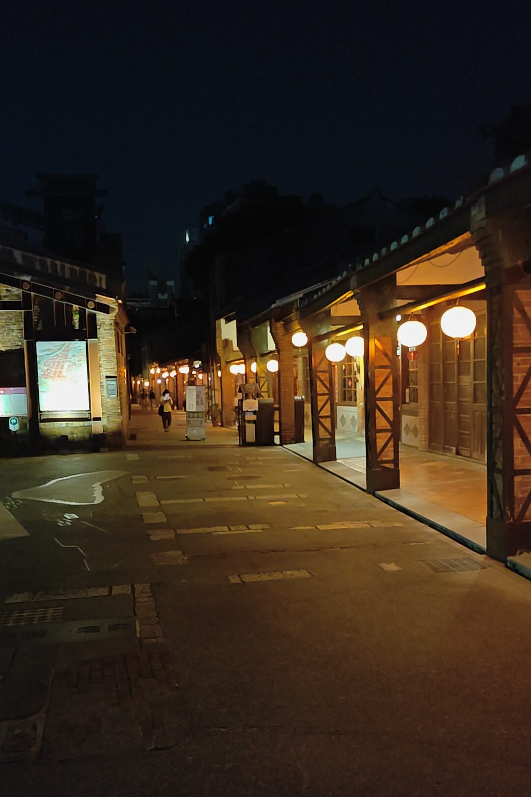 Lantern-lit covered walkway at night